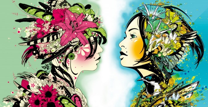 Two women with floral and feathered headdresses facing each other