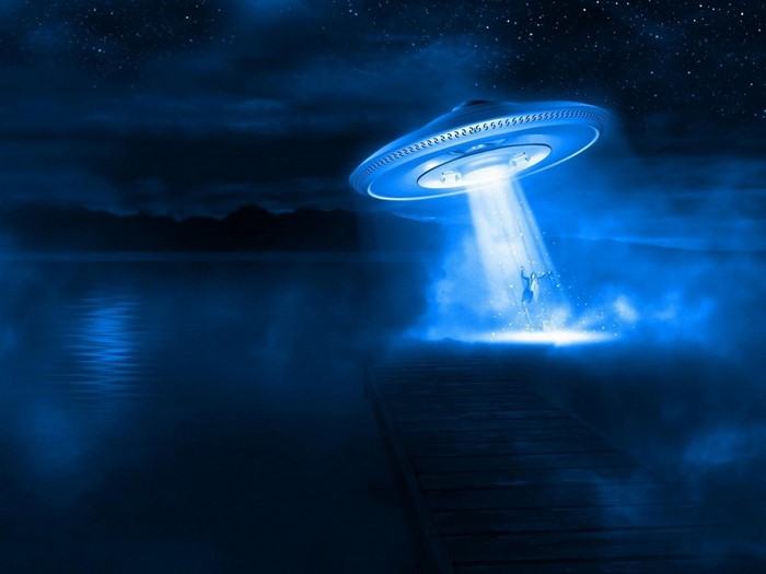 UFO abducting a person from a pier at night