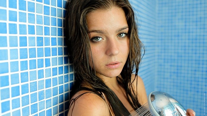 Lily C in a shower with a shower head