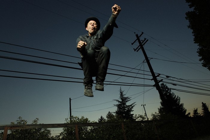 Tom Waits jumping in front of power lines