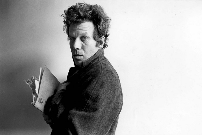 Tom Waits holding a book