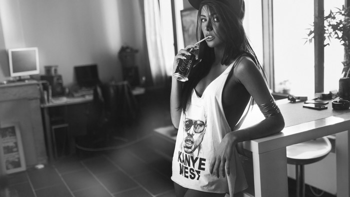 Woman wearing Kanye West t-shirt drinking Coca-Cola