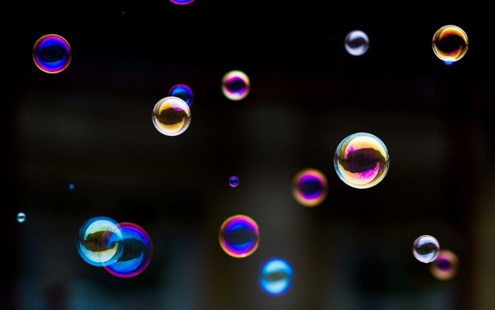 Colorful Floating Bubbles Against Dark Background