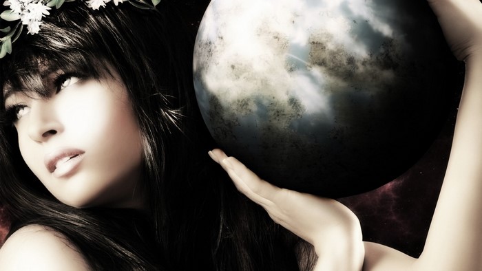 Woman wearing a flower crown holding a planet