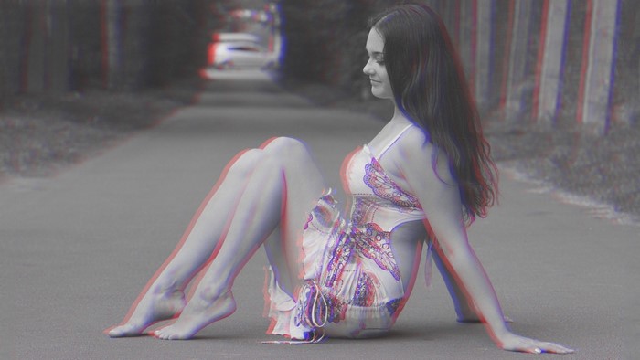 Woman sitting on a road with anaglyph 3D effect