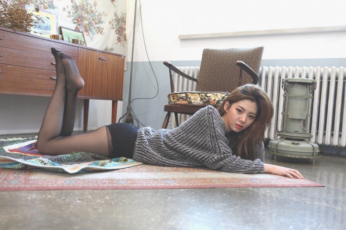 Young Woman Lying on Rug in Cozy Room