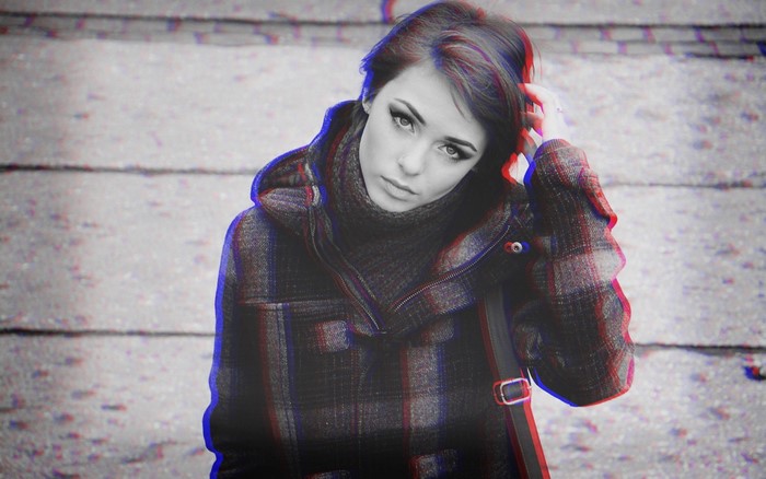 Woman with short hair wearing a plaid coat and turtleneck
