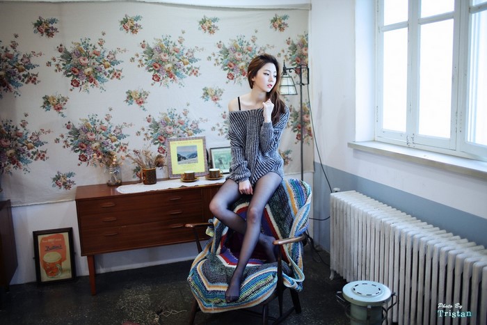 Chae Eun in a room with floral wallpaper