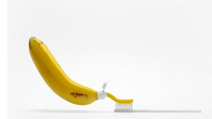 Banana as toothpaste tube on toothbrush