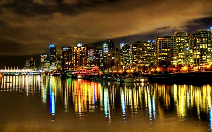 Vancouver cityscape at night with reflections on the water