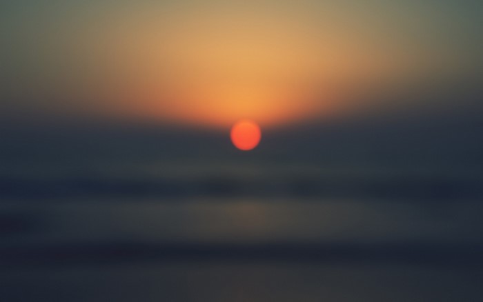 Sunset over the ocean with atmospheric haze
