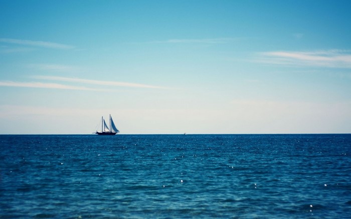 Sailboat on the blue ocean under a clear sky