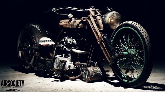Custom rusty motorcycle with green wheel