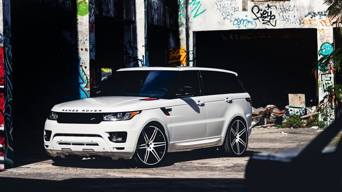 White Range Rover Sport parked in graffiti-covered urban area