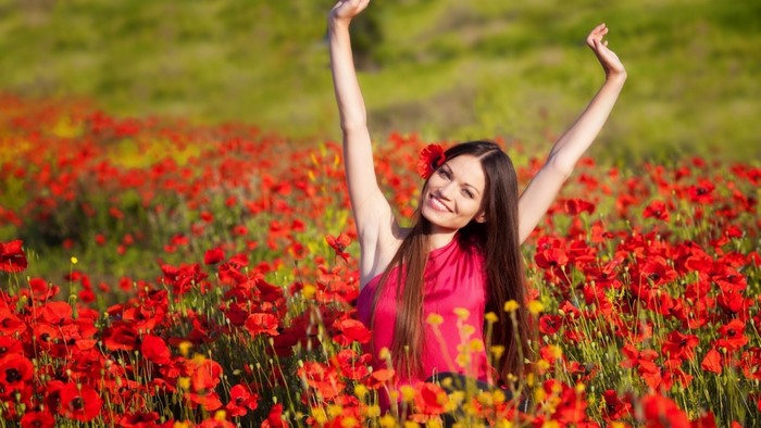 Woman in a field of red poppies