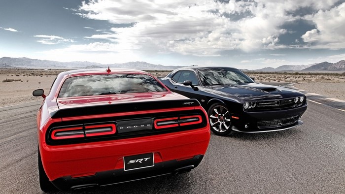 Two Dodge Challenger SRT cars on a desert road