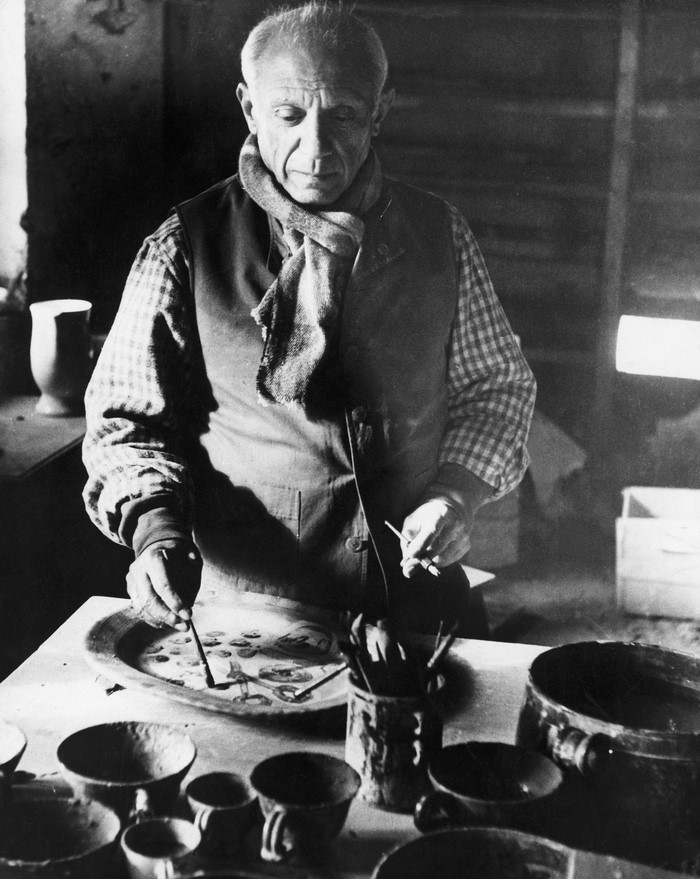 Pablo Picasso painting ceramics in his studio