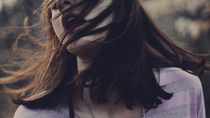 Woman with hair blowing across her face