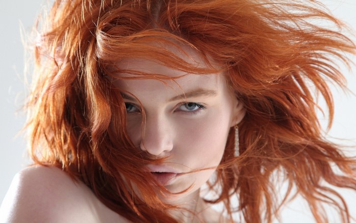 Close-up portrait of a redhead woman with wavy hair