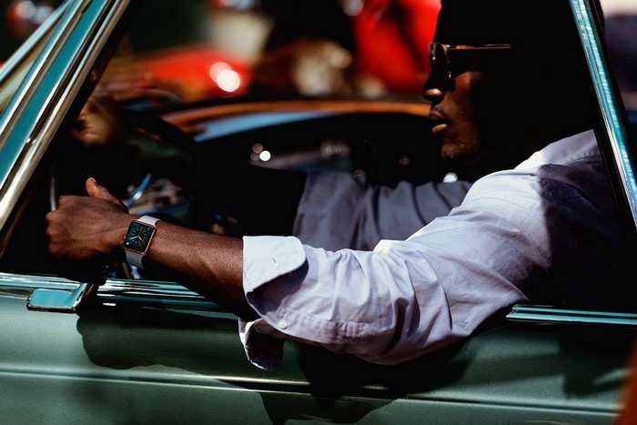 Man wearing a watch driving a car