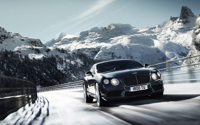Bentley Continental GT driving on a snowy mountain road