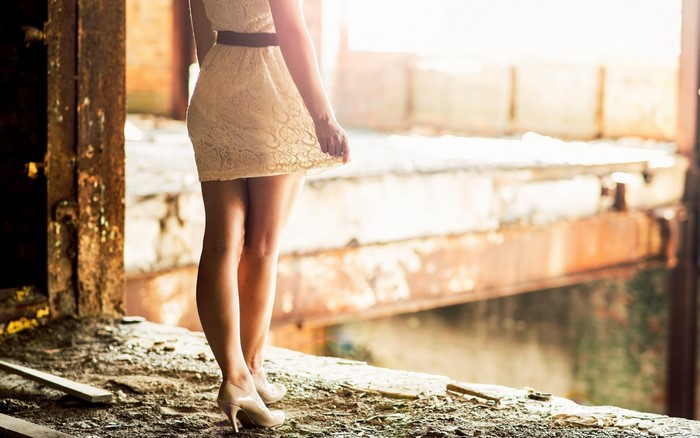 Woman in white dress standing in abandoned building
