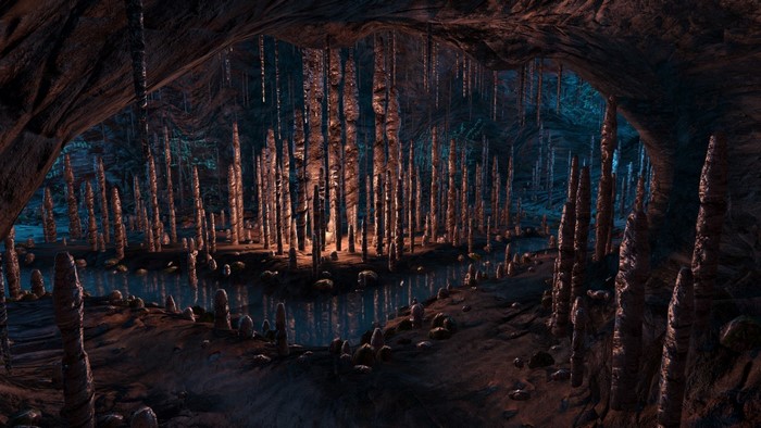 Cave with stalagmites and stalactites and a body of water