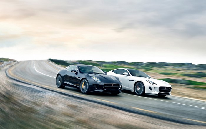 Two Jaguar F-Type cars on a winding road