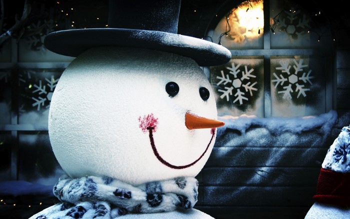 Close-up of a snowman with a hat and scarf