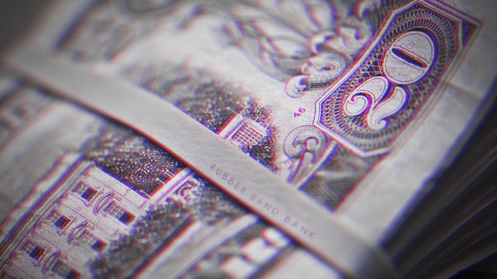 Close up of a rubber band around a stack of money