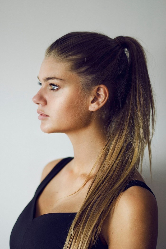 Woman with long brown hair in a ponytail
