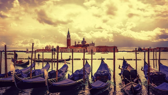 Gondolas docked in Venice with San Giorgio Maggiore church