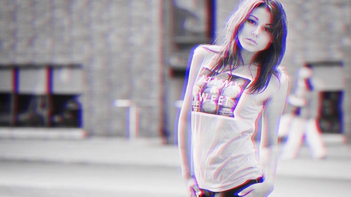 Woman wearing a white tank top with text