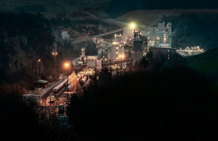 Industrial complex at night with trains