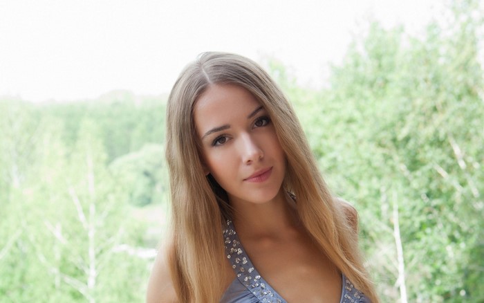 Woman with long blonde hair in a sparkly dress