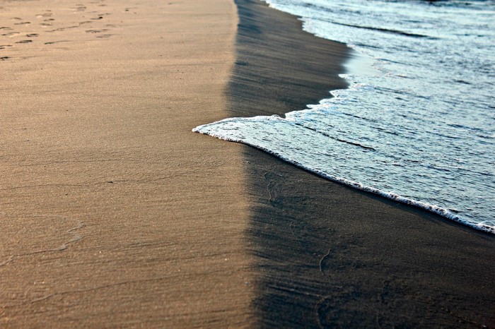 Ocean waves washing onto a sandy beach