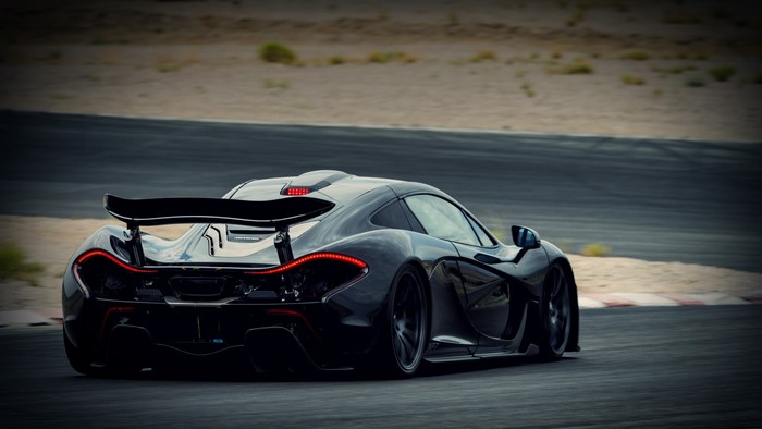 Black McLaren P1 supercar on a race track