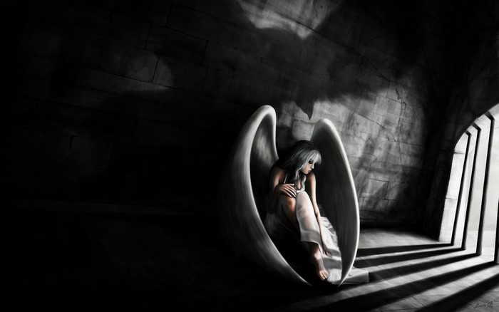 Sad angel with white wings in a dark cave