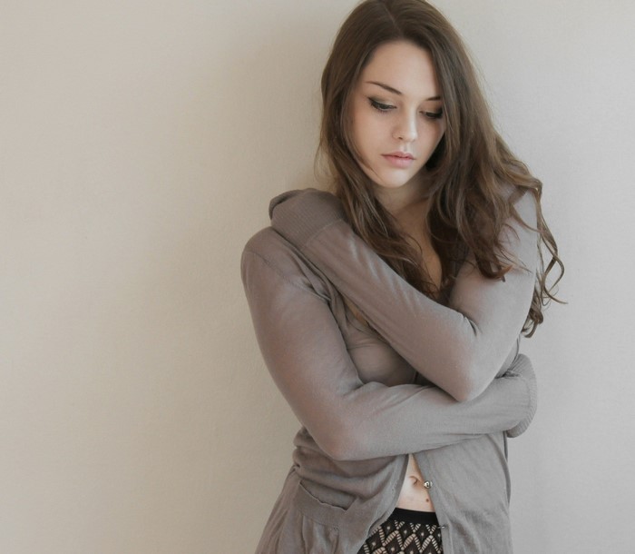 Thoughtful Young Woman in Gray Sweater