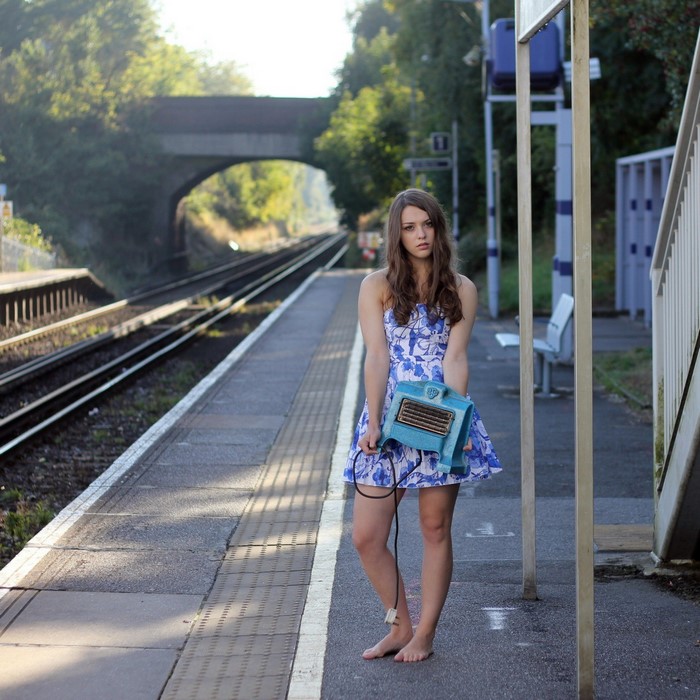 Imogen Dyer holding a blue heater at a train station