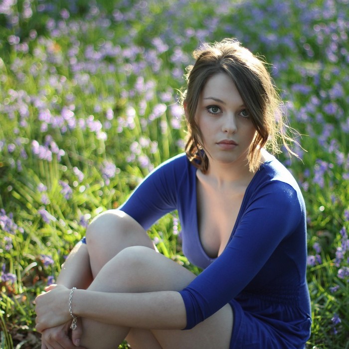Woman Sitting in a Meadow with Purple Flowers