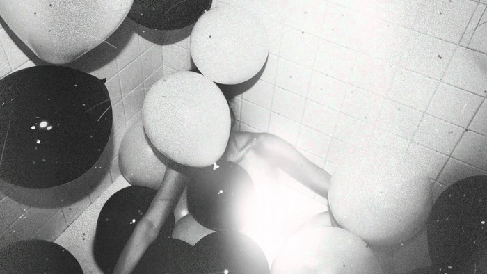 The Weeknd surrounded by balloons