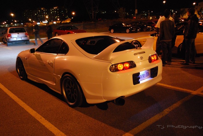 White Toyota Supra with spoiler at night