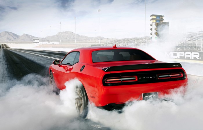 Red Dodge Challenger SRT Burning Rubber on Drag Strip