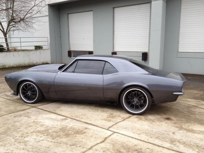 Custom gray Chevrolet Camaro parked outside a building