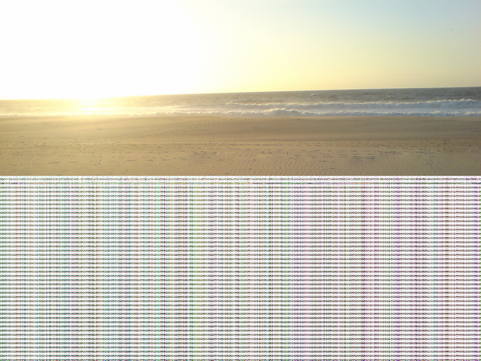 Beach with ocean waves and sand dunes at sunset