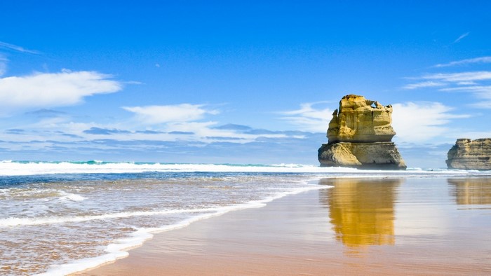 Rock formations on a beach with waves and reflections