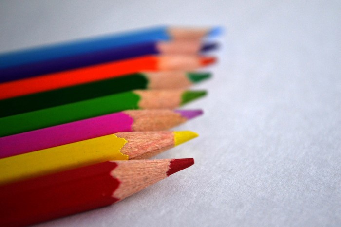 Close-up of colored pencils on a white surface