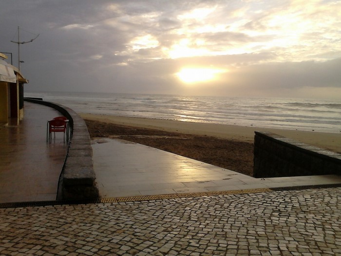 Beach walkway at sunset with ocean waves