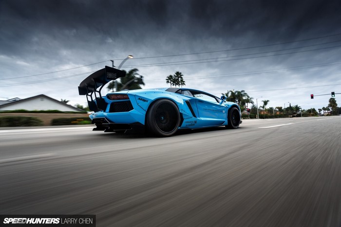 Blue Lamborghini Aventador LB Works driving on road